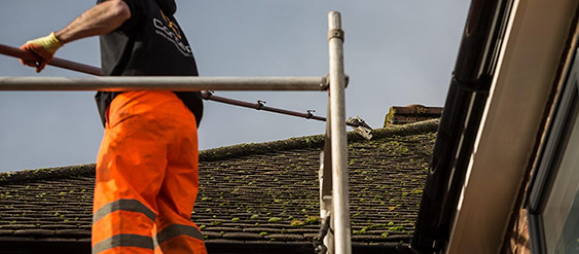 Concept Roof Cleaning Team Removing Moss From Concrete Roof Tiles